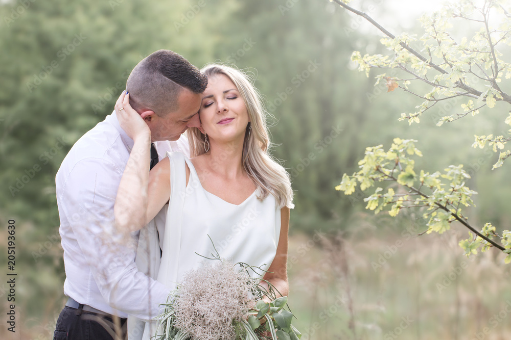 beautiful people love kissing, newlyweds, a young couple, outdoor session. The bride in a white dress. Love, wedding and passion beautiful people love kissing, newlyweds, a young couple, outdoor session. The bride in a white dress. Love, wedding and passion