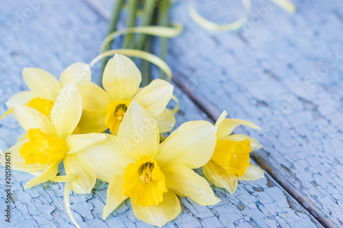 A bouquet of yellow narcissus on the wooden boards