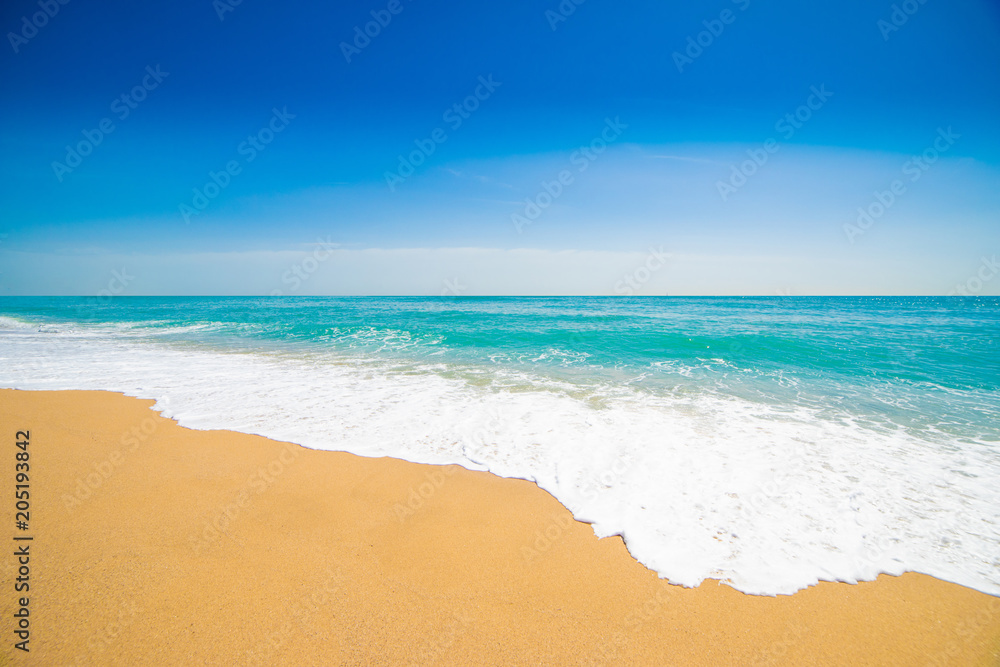 Beautiful Tropical  beach with Soft wave of blue ocean, sand and transparent sky. Summer travel holiday background concept. Sea panorama.