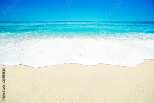 Beautiful Tropical beach with Soft wave of blue ocean, white sand and transparent sky. Summer travel holiday background concept. Sea panorama.