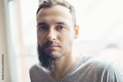 Fototapeta Handsome man half beard standing in front of white background with half of his f