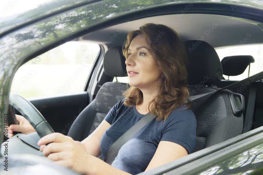 Woman driving car and looking outside