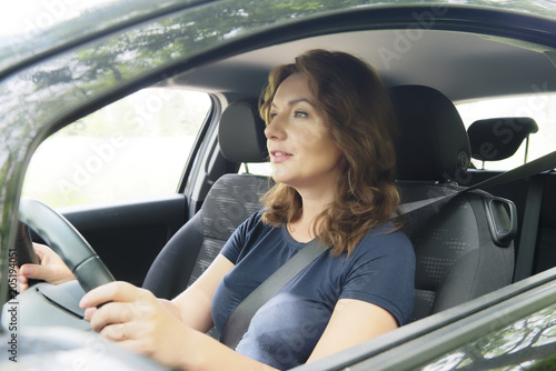 Woman driving car and looking outside
