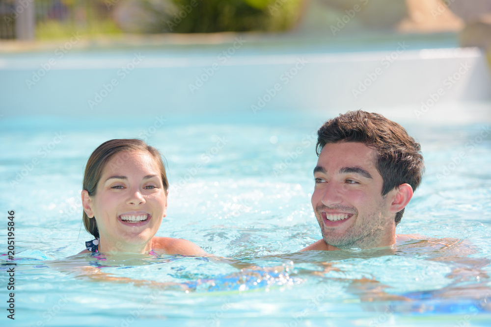 Man and woman swimming in pool