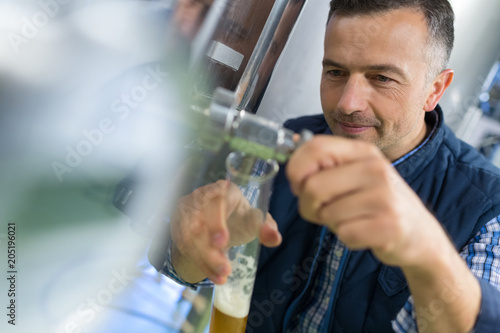 manufacturer holding beer glass at brewery © auremar
