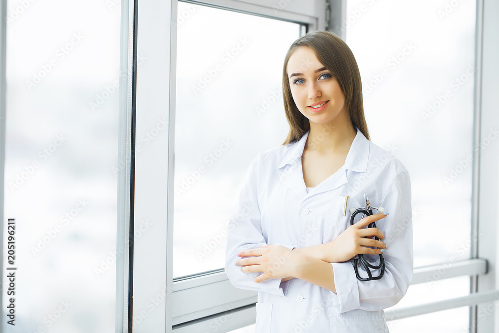Health Care. Female doctor standing in hospital corridor. Medical Concept Health Care. Female doctor standing in hospital corridor. Medical Concept