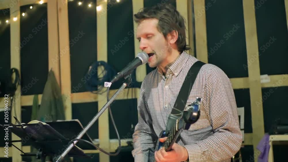 Man lead guitarist playing guitar and sing song at garage Man lead guitarist playing guitar and sing song at garage