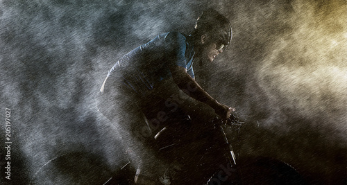 Cyclist cycling on mountain bike with rainy ,foggy on black background.