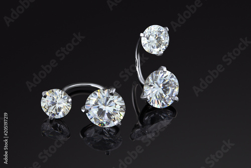 Fine luxury jewelry set of white gold earrings with dianomds isolated on black background.