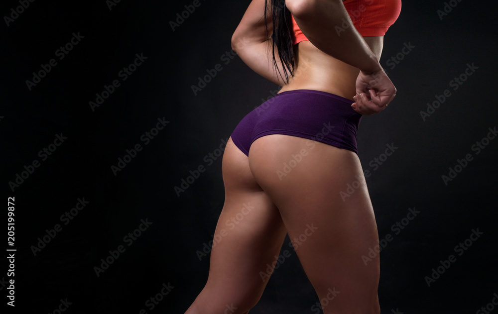 Fototapeta premium Girl. Fitness model, view from behind. Beautiful thigh.