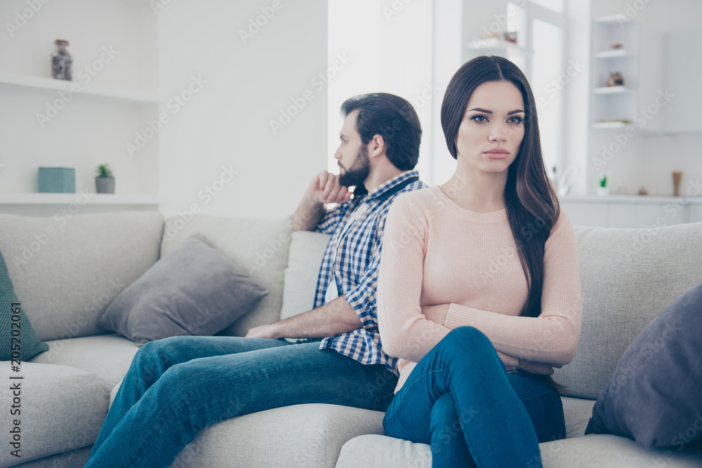 Obraz premium Portrait of sad couple having conflict upset girl sitting with crossed folded hands ignore her boyfriend after scandal they do not speak with each other having distrust disrespect