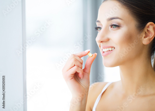 Dental care. Beautiful young woman eating chewing gum, smiling. photo
