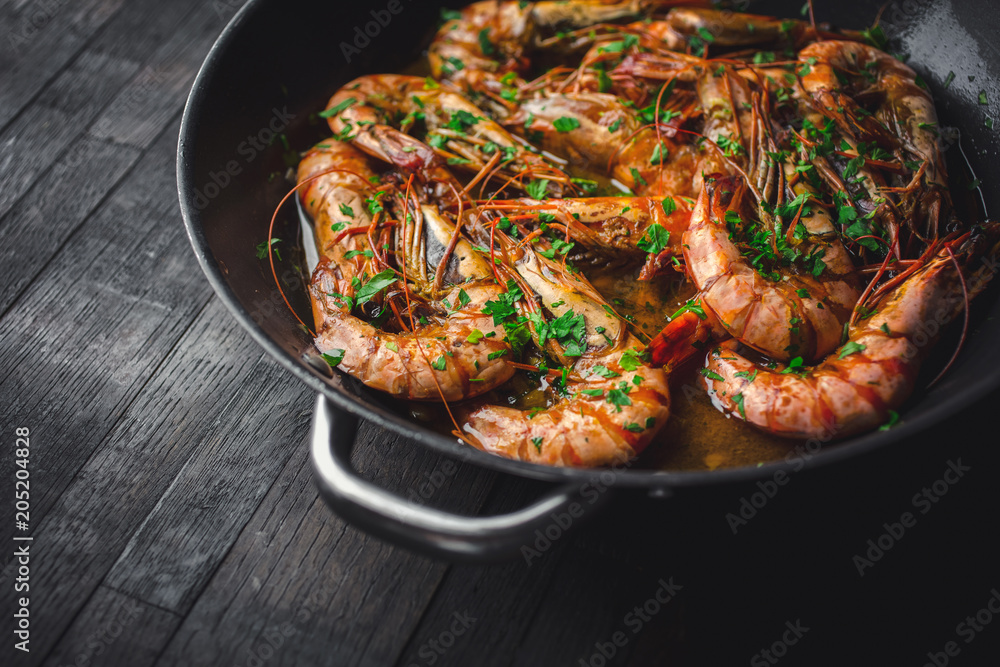 Shrimps fried in a pan. Classic recipe - parsley, garlic, chilli peppers and white wine. Shrimps fried in a pan. Classic recipe - parsley, garlic, chilli peppers and white wine.