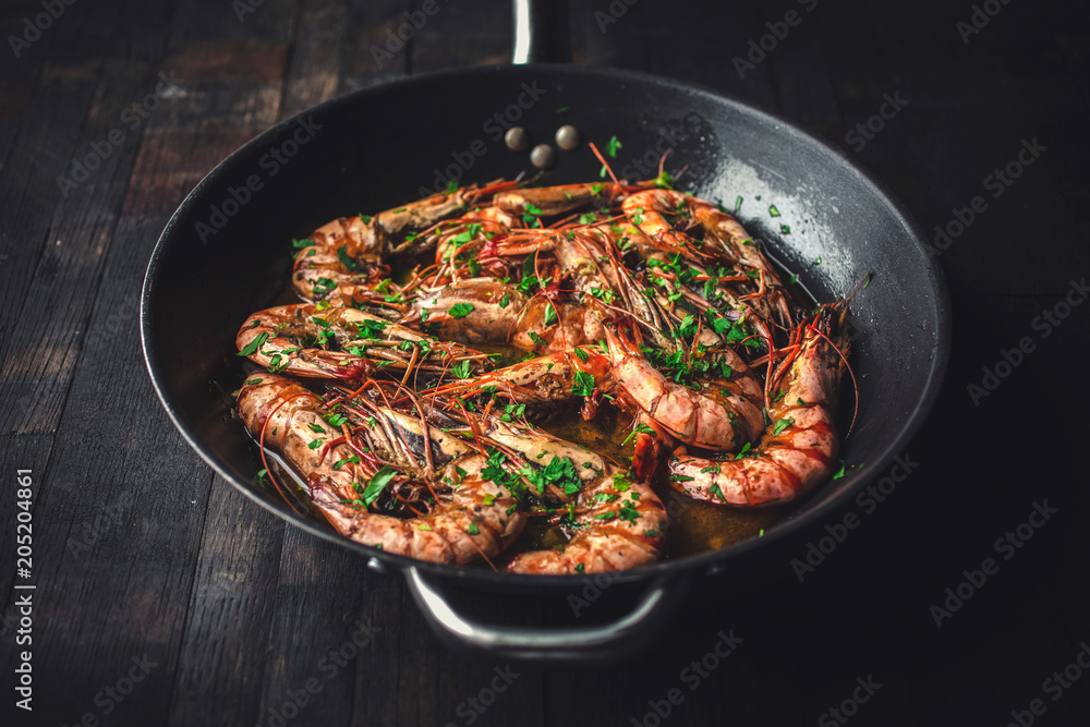 Shrimps fried in a pan. Classic recipe - parsley, garlic, chilli peppers and white wine. Shrimps fried in a pan. Classic recipe - parsley, garlic, chilli peppers and white wine.