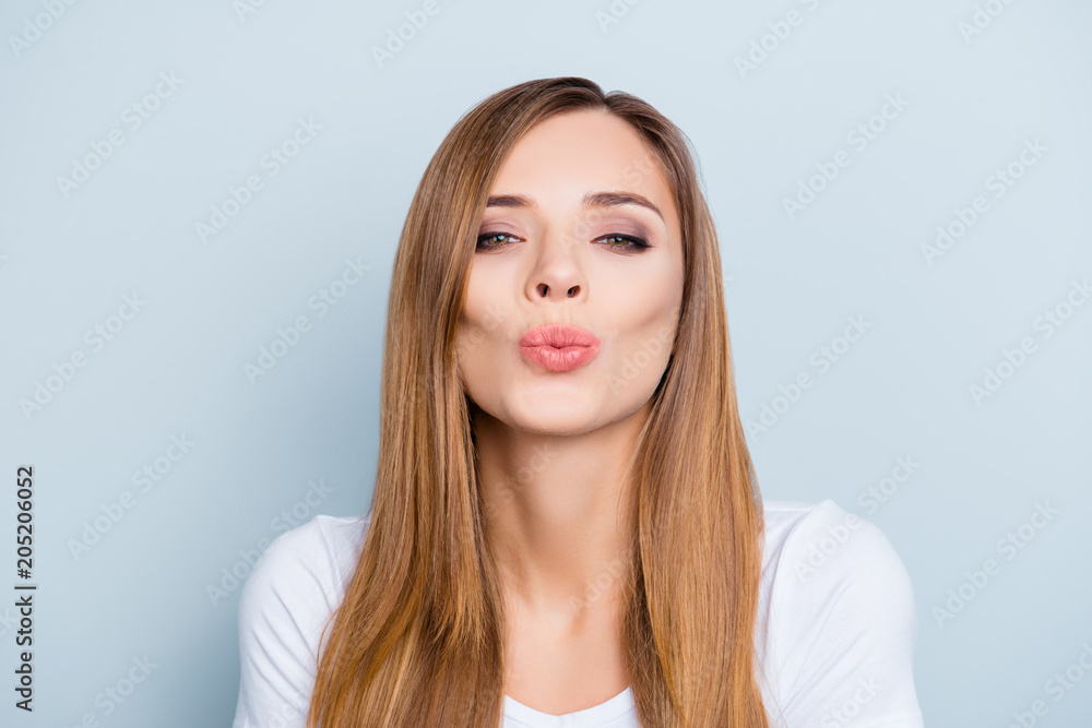 Portrait of lovely cute brown-haired girl sending kiss with pout lips isolated on grey background looking at camera Portrait of lovely cute brown-haired girl sending kiss with pout lips isolated on grey background looking at camera
