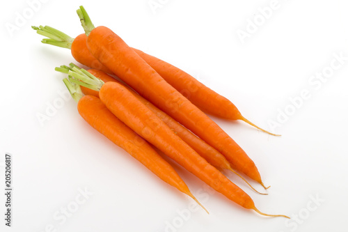 Carrot vegetable with leaves on the wooden background.