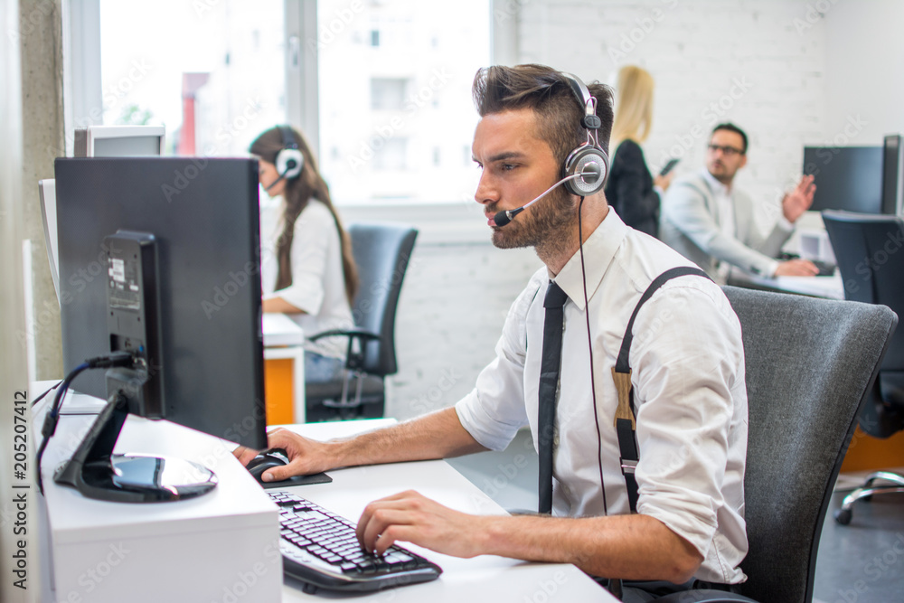 Beautiful handsome man with headset working in call center. Beautiful handsome man with headset working in call center.