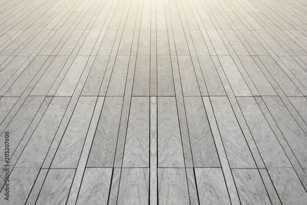 The surface with elongated rectangular stone tiles of gray color goes into perspective.