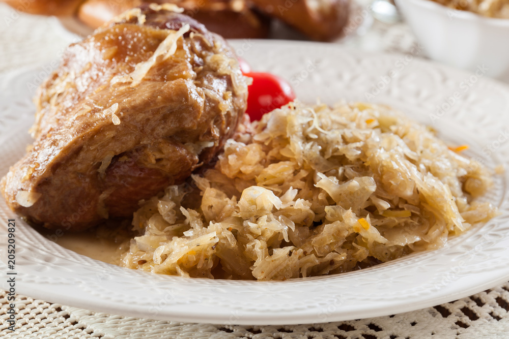 Pork knuckle with fried sauerkraut and tomatoes Pork knuckle with fried sauerkraut and tomatoes