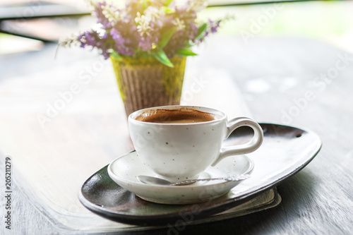 Closeup of coffee cup on wooden table in morning time. Feel refreshed and relaxing with the coffee drinking concept. 
