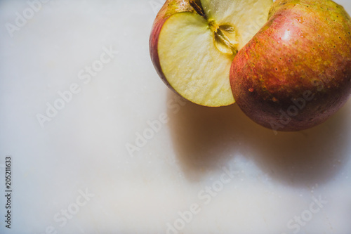 A Half  Cut Red Apple on a Chooping Board photo