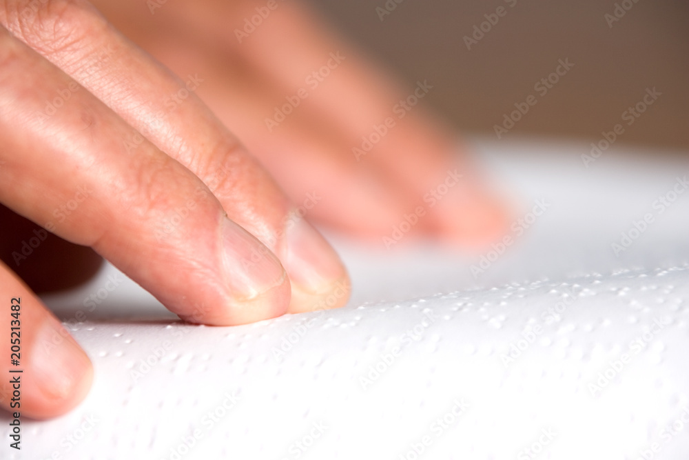 Hands reading braille Hands reading braille