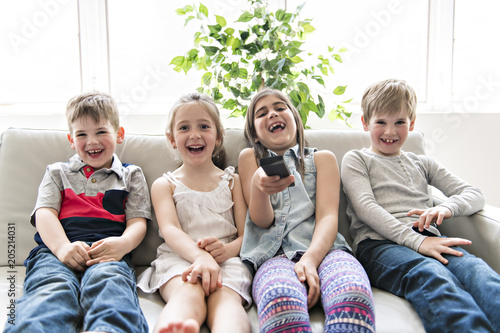 Group Of Young Friends Together on the sofa listening tv photo