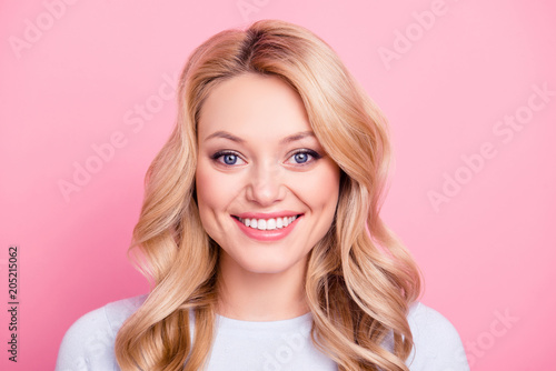 Portrait of pretty cute girl in casual outfit with modern hairdo big eyes beaming smile looking at camera isolated on pink background photo