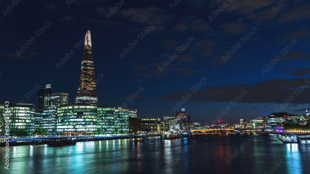 Panoramic view of London skyline at night on River Thames