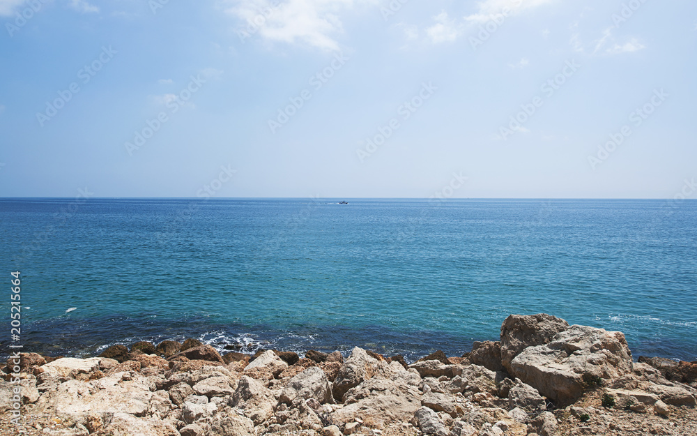 Rocks and sea on the coast under a blue sky. Landscape. Rocks and sea on the coast under a blue sky. Landscape.
