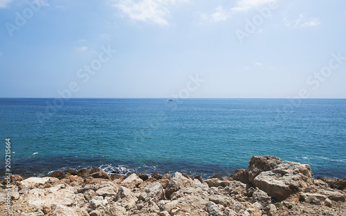 Rocks and sea on the coast under a blue sky. Landscape.