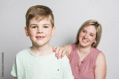 Mother and son on studio white background