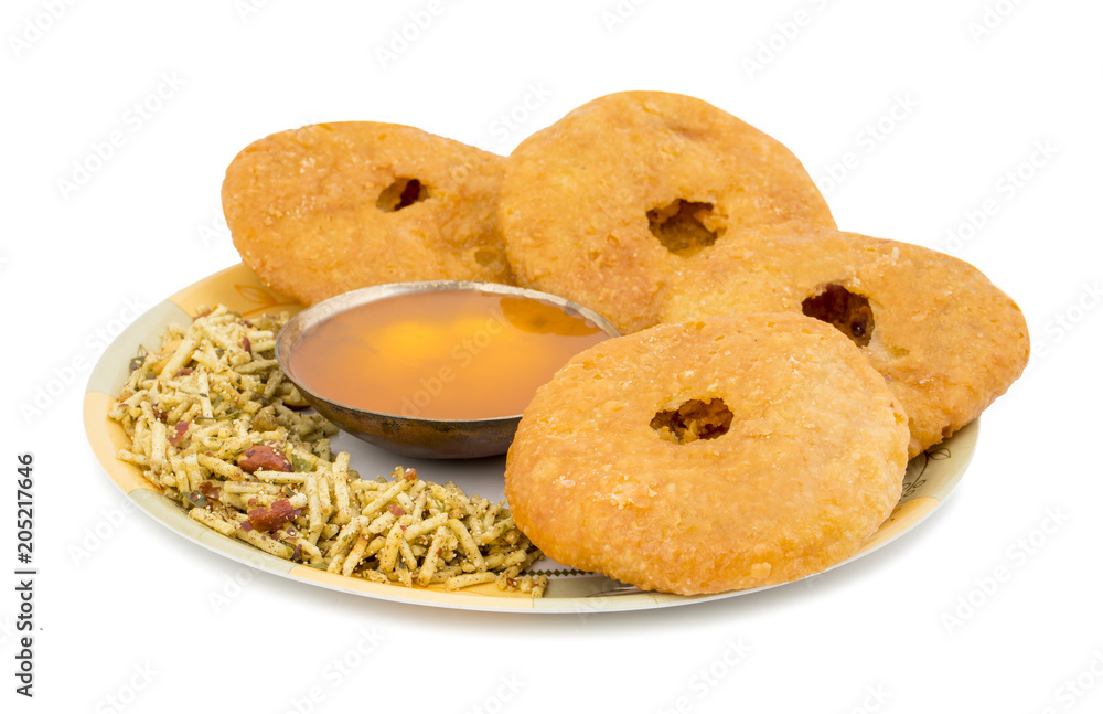 Indian Traditional Sweet Kachori Also Know As Mawa Kachori, Kachauri or Kachodi, Stuffed Kachori With Condensed Milk, Cheese and Dry Fruits And Served With Sugar Syrup isolated on White Background Indian Traditional Sweet Kachori Also Know As Mawa Kachori, Kachauri or Kachodi, Stuffed Kachori With Condensed Milk, Cheese and Dry Fruits And Served With Sugar Syrup isolated on White Background