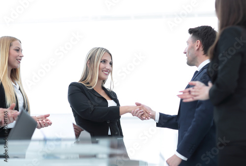 handshake business partners after discussion of the contract