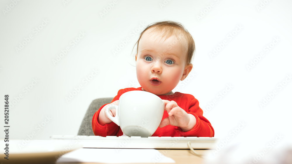 Happy child baby girl toddler sitting with keyboard of computer isolated on a white background Happy child baby girl toddler sitting with keyboard of computer isolated on a white background