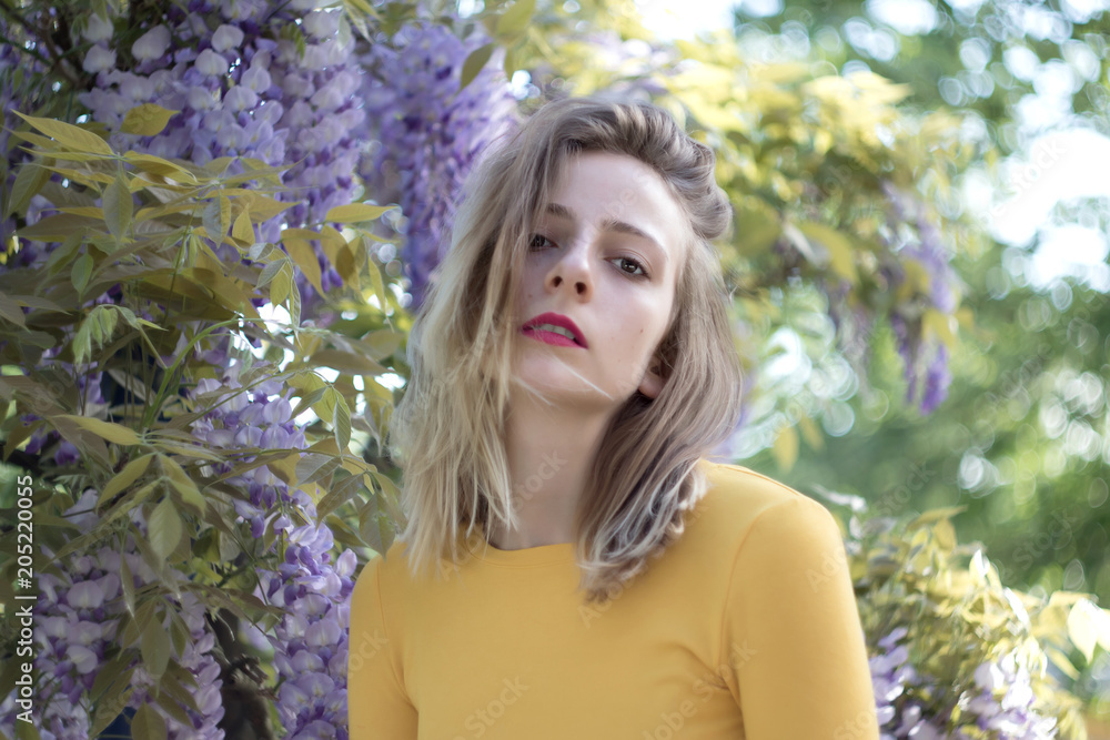 Portrait of a young woman on a wisteria background Portrait of a young woman on a wisteria background