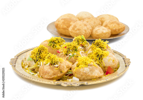 Indian Spicy Chaat Item Sev Puri Stuffed With Potato, Sev Namkeen, Coriander, Chutney isolated on White Background. It is a Most Popular Snack of Mumbai, Maharashtra