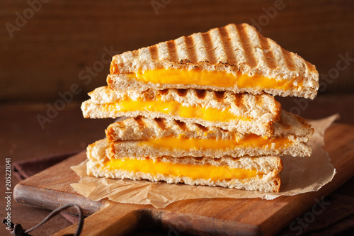 grilled cheese sandwich on rustic brown background