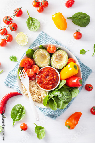 vegan buddha bowl. healthy lunch bowl with avocado, tomato, bell peppers, quinoa and salsa