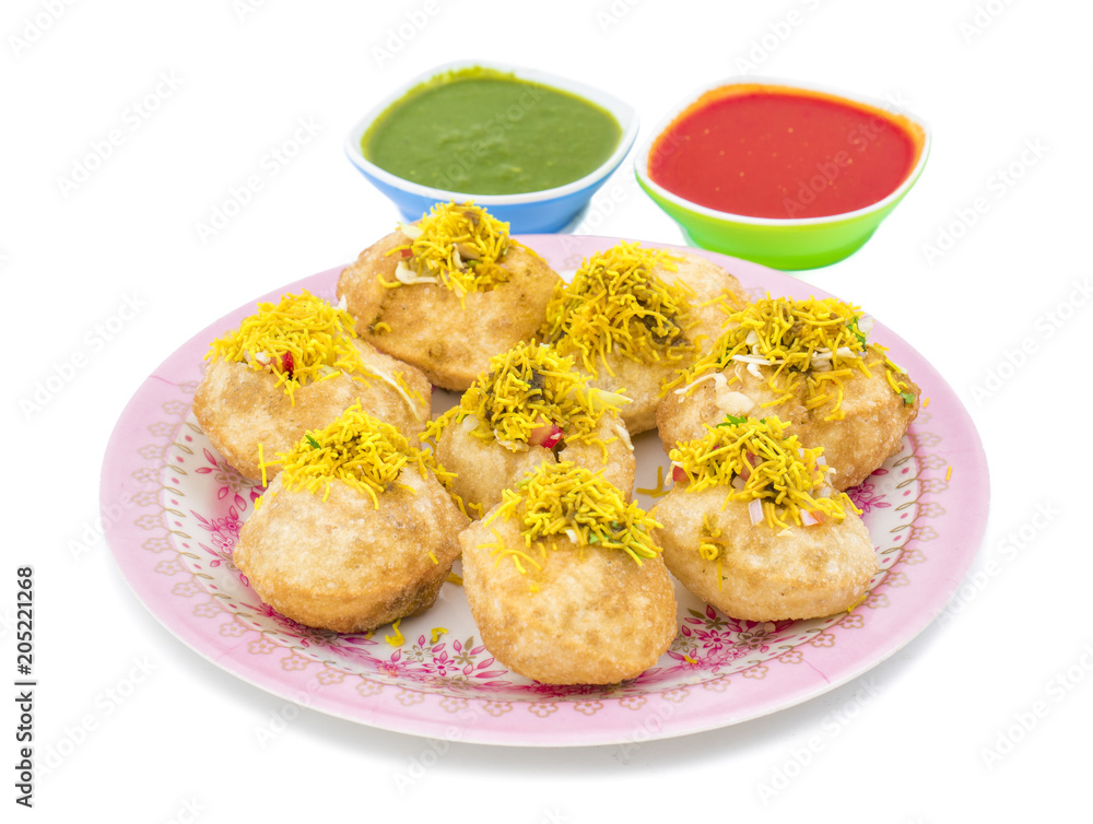 Indian Spicy Chaat Item Sev Puri Stuffed With Potato, Sev Namkeen, Coriander, Chutney isolated on White Background. It is a Most Popular Snack of Mumbai, Maharashtra