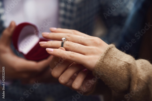 Close up. Man makes proposal of marriage to girl. photo