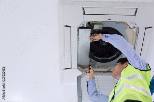 Technician is checking air conditioner.