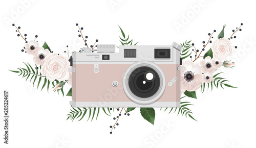 Vintage retro photo camera in flowers, leaves, branches on white background