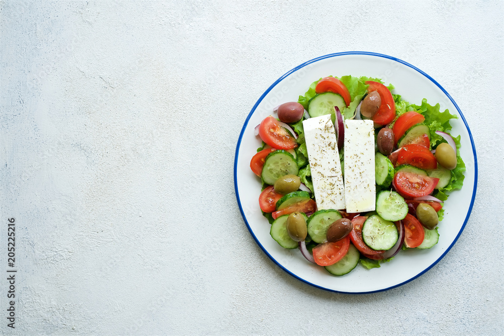 Traditional Greek salad. Light and healthy food. White food background