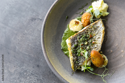 Plate with tasty fish steak on grey background