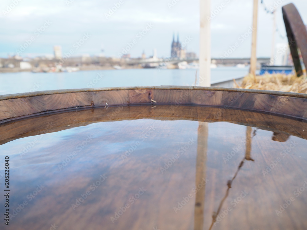 Barrel with water reflects Cologne dome, Germany