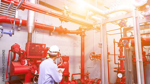 Engineer check red generator pump for water sprinkler piping and fire alarm control system. photo