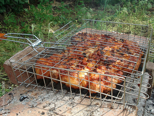 Meat on the brazier. Shish kebab in the fresh air. Grilled meat, barbecue. photo