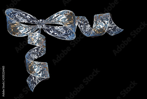 Transparent shiny curled blue-silver ribbon bow isolated on black background