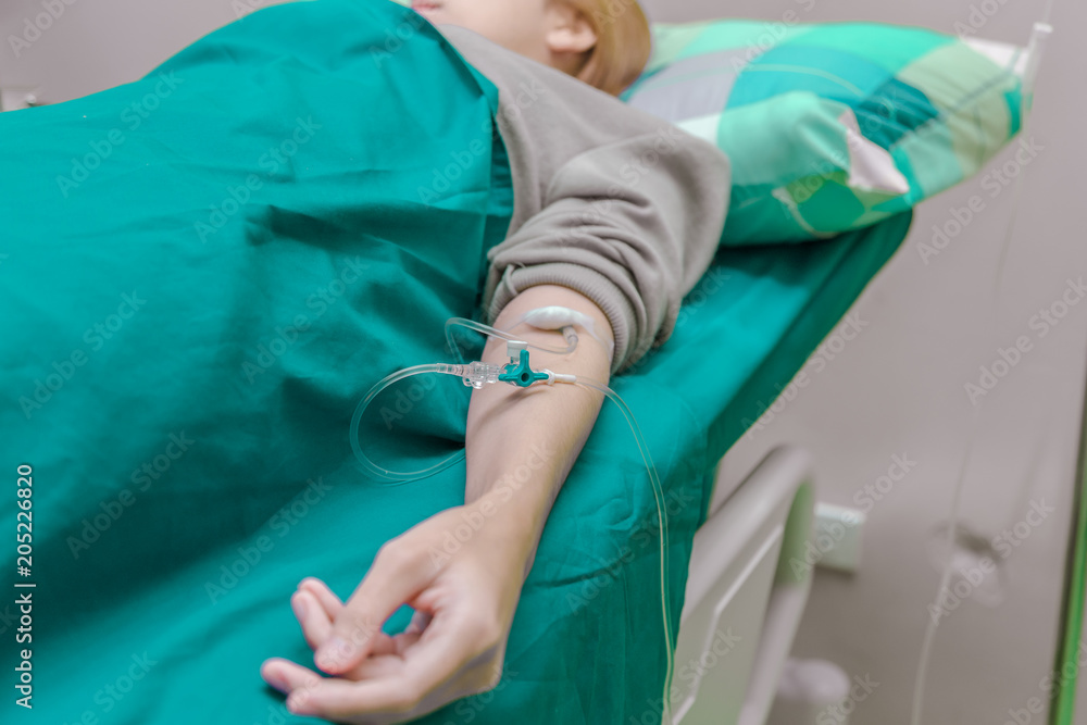 Patient is on drip receiving a saline solution in hospital. Patient is on drip receiving a saline solution in hospital.